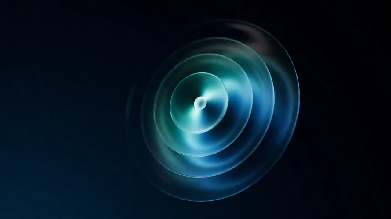 Concentric translucent shells nested around a small bright core, teal and blue light passing through each layer
