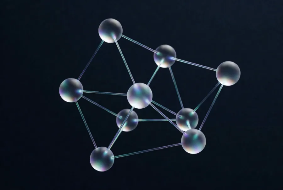 Frosted glass spheres joined by thin glass rods into a loose lattice, like a molecule model