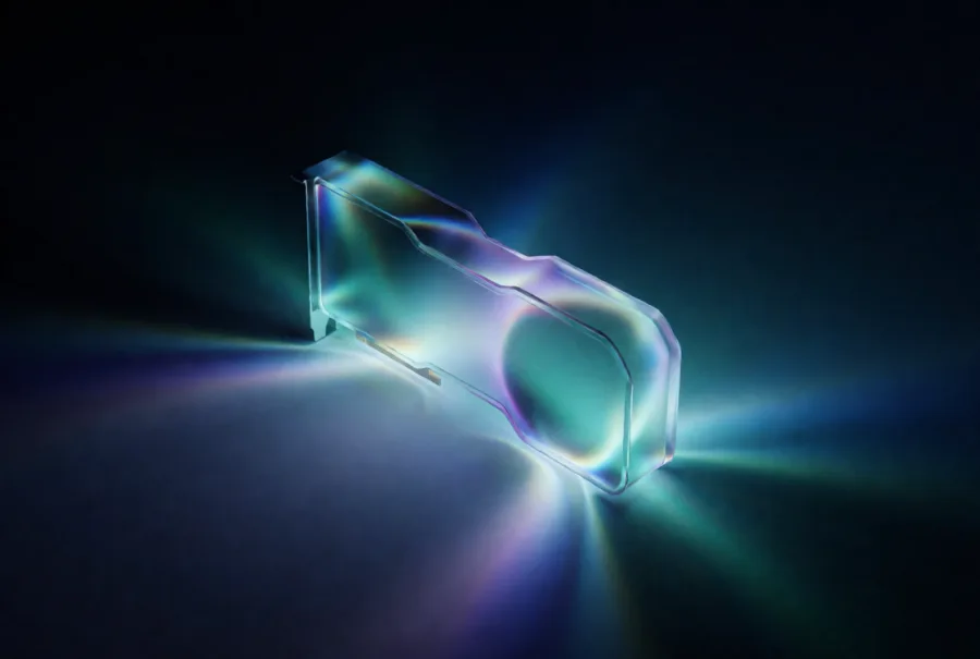 A graphics card cast in clear glass on a dark reflective surface, iridescent light spilling from both ends